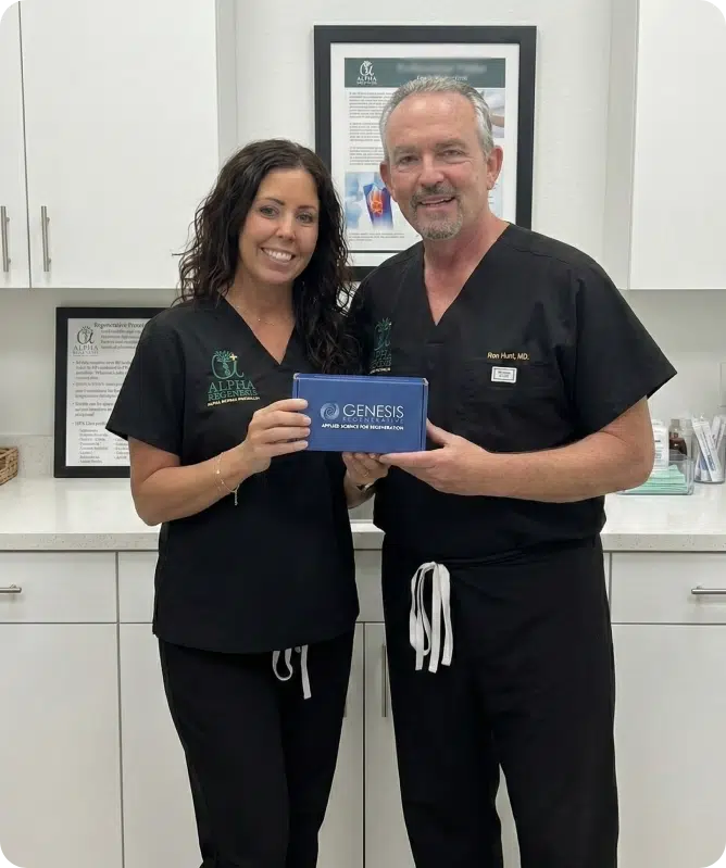Alpha Regenesis founders Nicole Capobianco, RN, and Dr. Ron Hunt holding a Genesis Regenerative Protein Array product box, introducing the new standard in advanced restorative medicine to the Naples area.