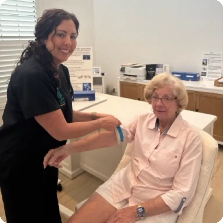 Nicole Capobianco, RN, conducting a mobile regenerative medicine house call with a patient, demonstrating the Alpha Regenesis standard of concierge care that removes the friction of traditional waiting rooms.